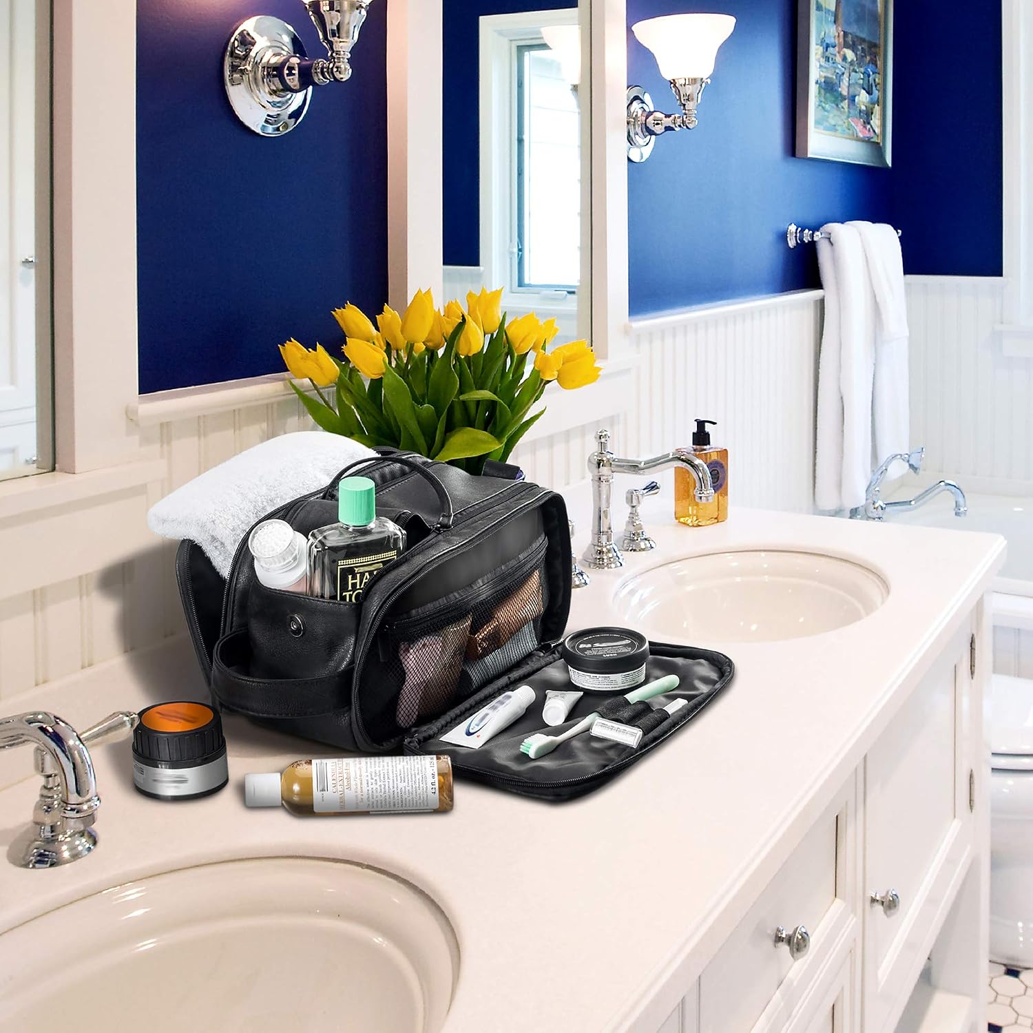 Elviros toiletry bag open on a hotel bathroom counter with toiletries laid out