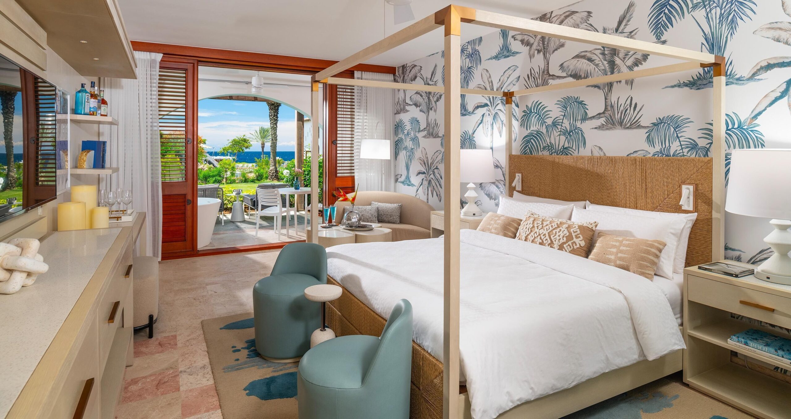 Four-poster suite with a soaking tub and ocean-view terrace at Sandals Royal Curaçao