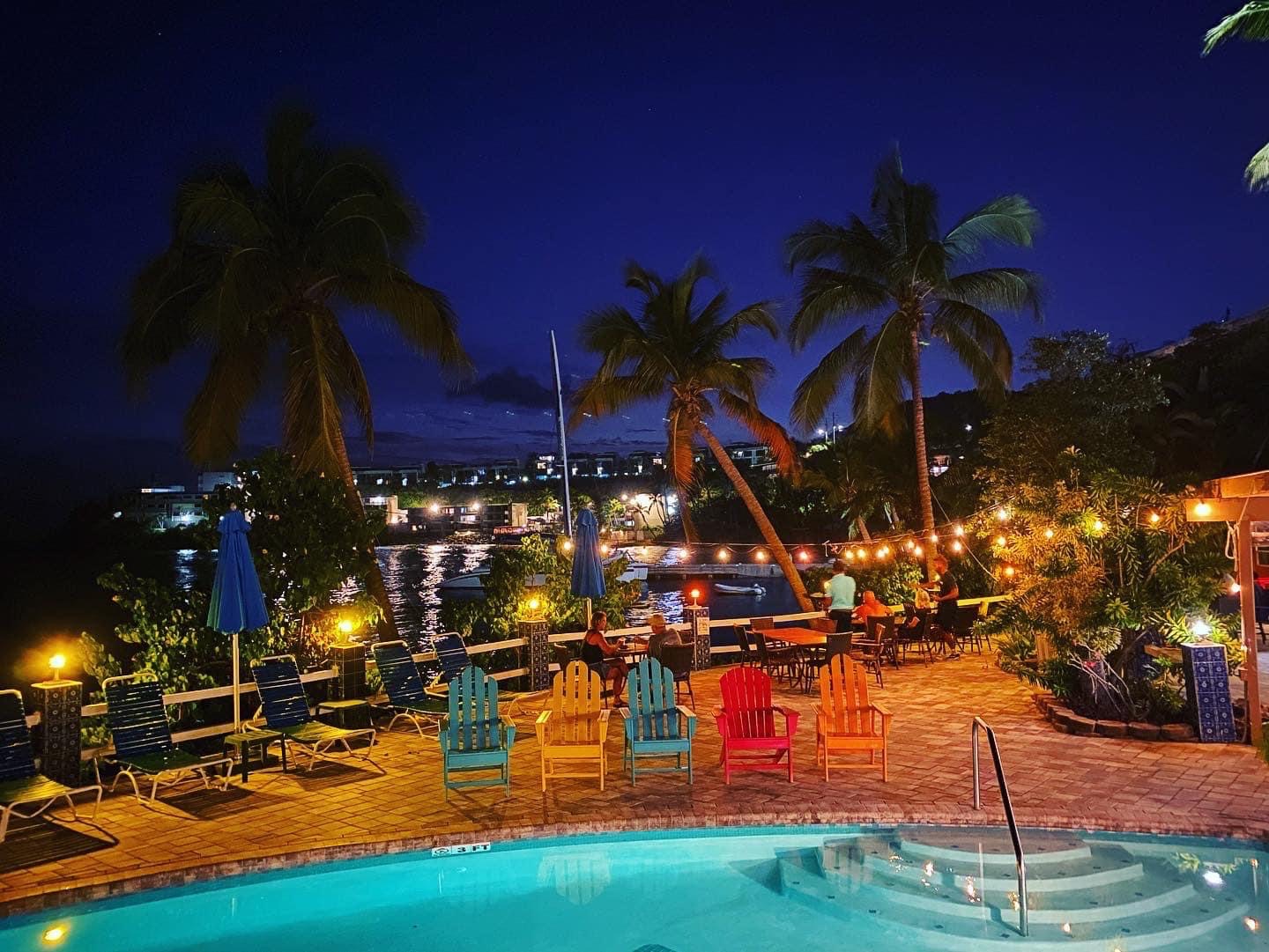 The pool and dining terrace lit up in the evening at Bolongo Bay Beach Resort