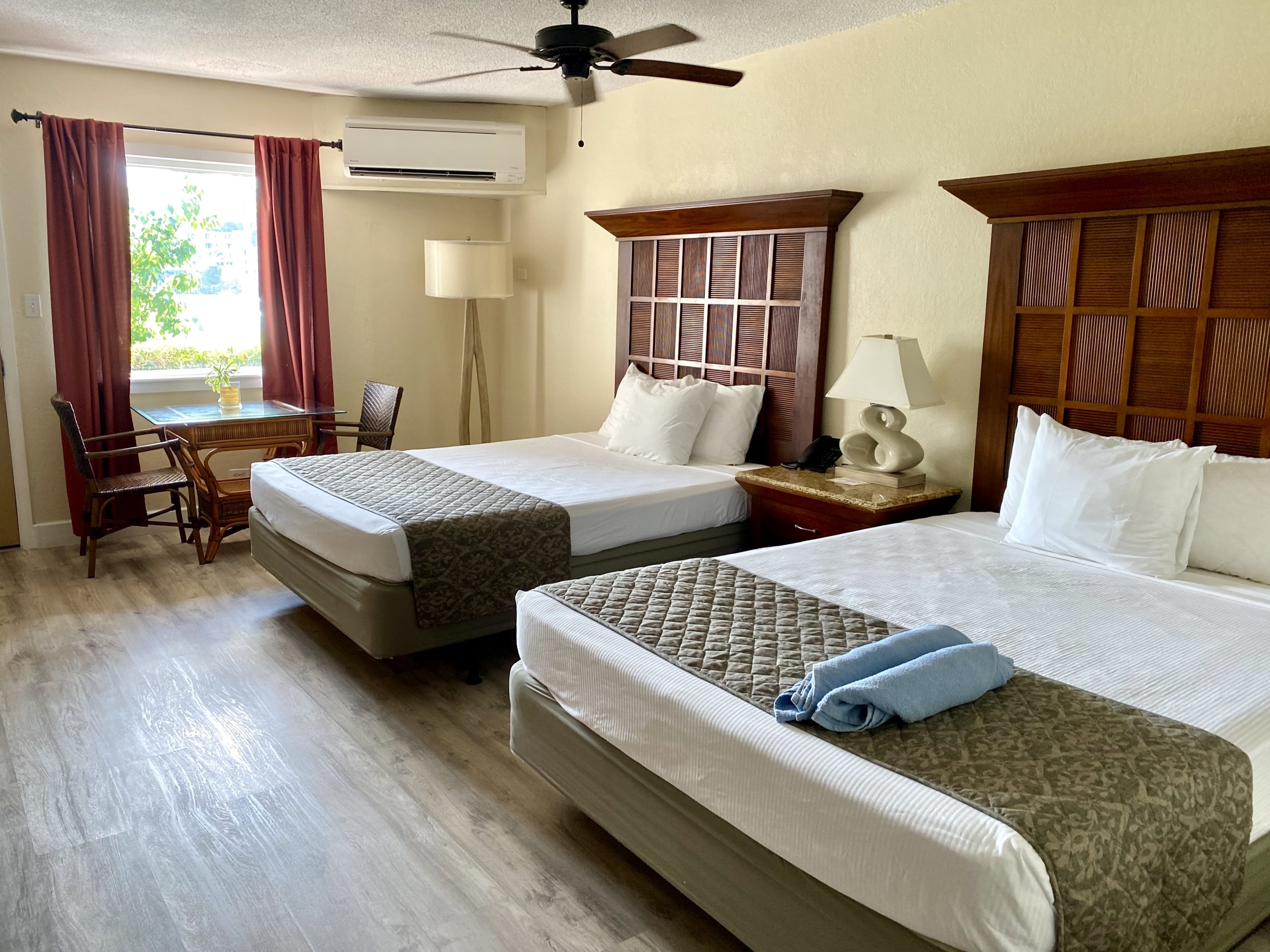 Guest room with two beds and wooden headboards at Bolongo Bay Beach Resort, St. Thomas