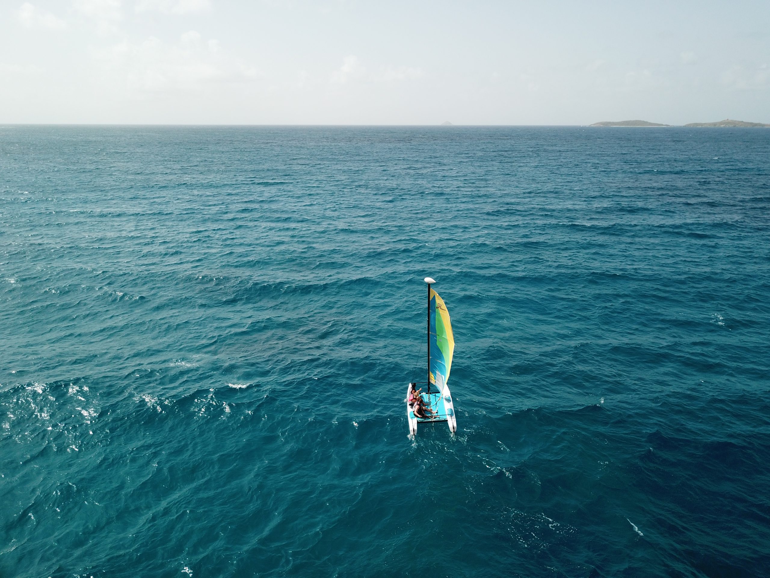 Guests sailing a Hobie Cat off Bolongo Bay, included in the resort's all-inclusive package