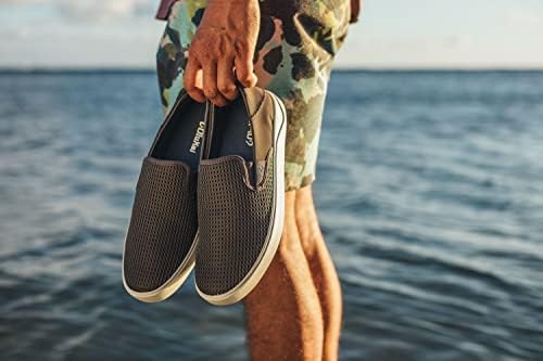 OluKai Lae'ahi slip on shoes carried by the water, worn without socks