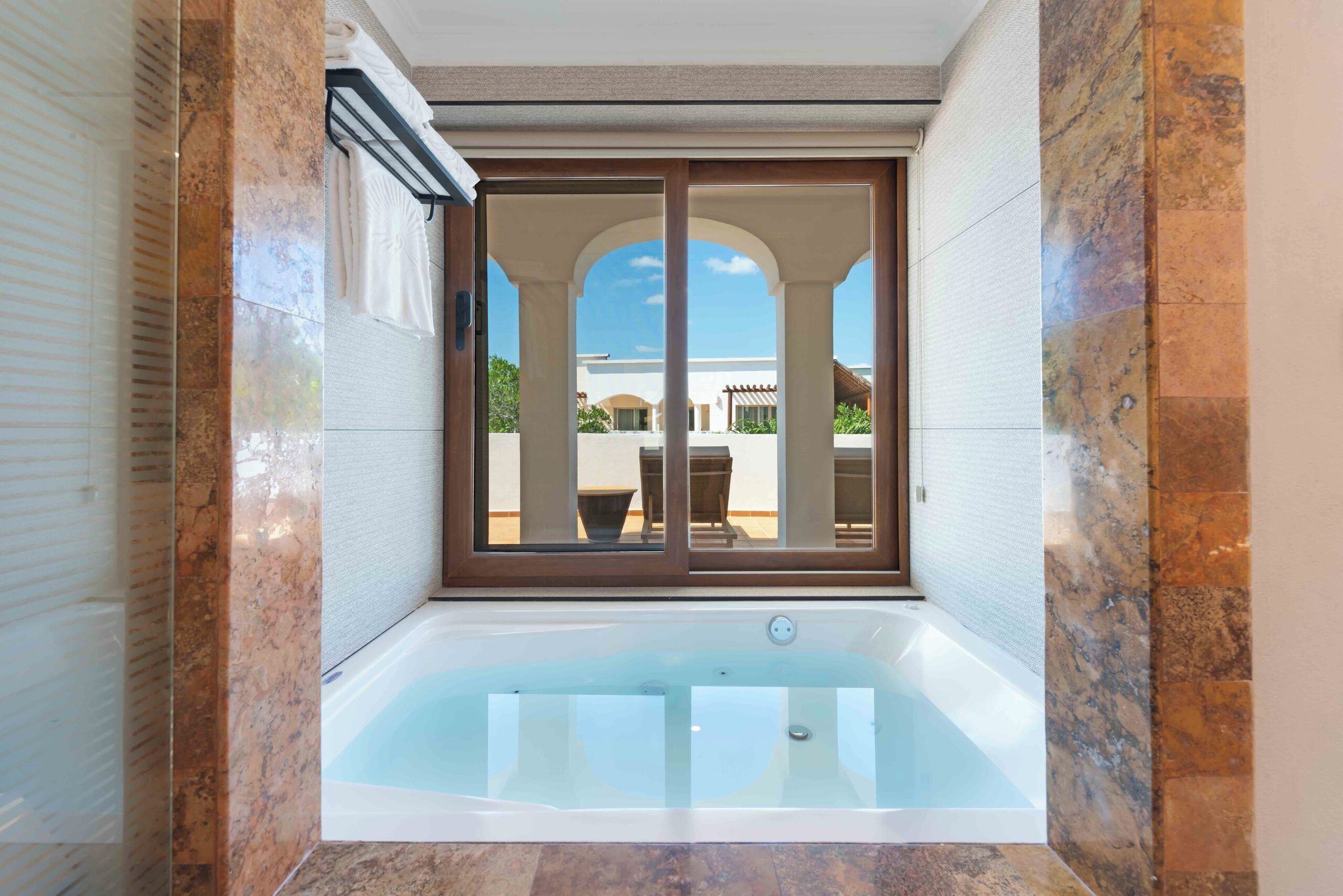 In-suite jacuzzi tub with a private terrace at Valentin Imperial Riviera Maya