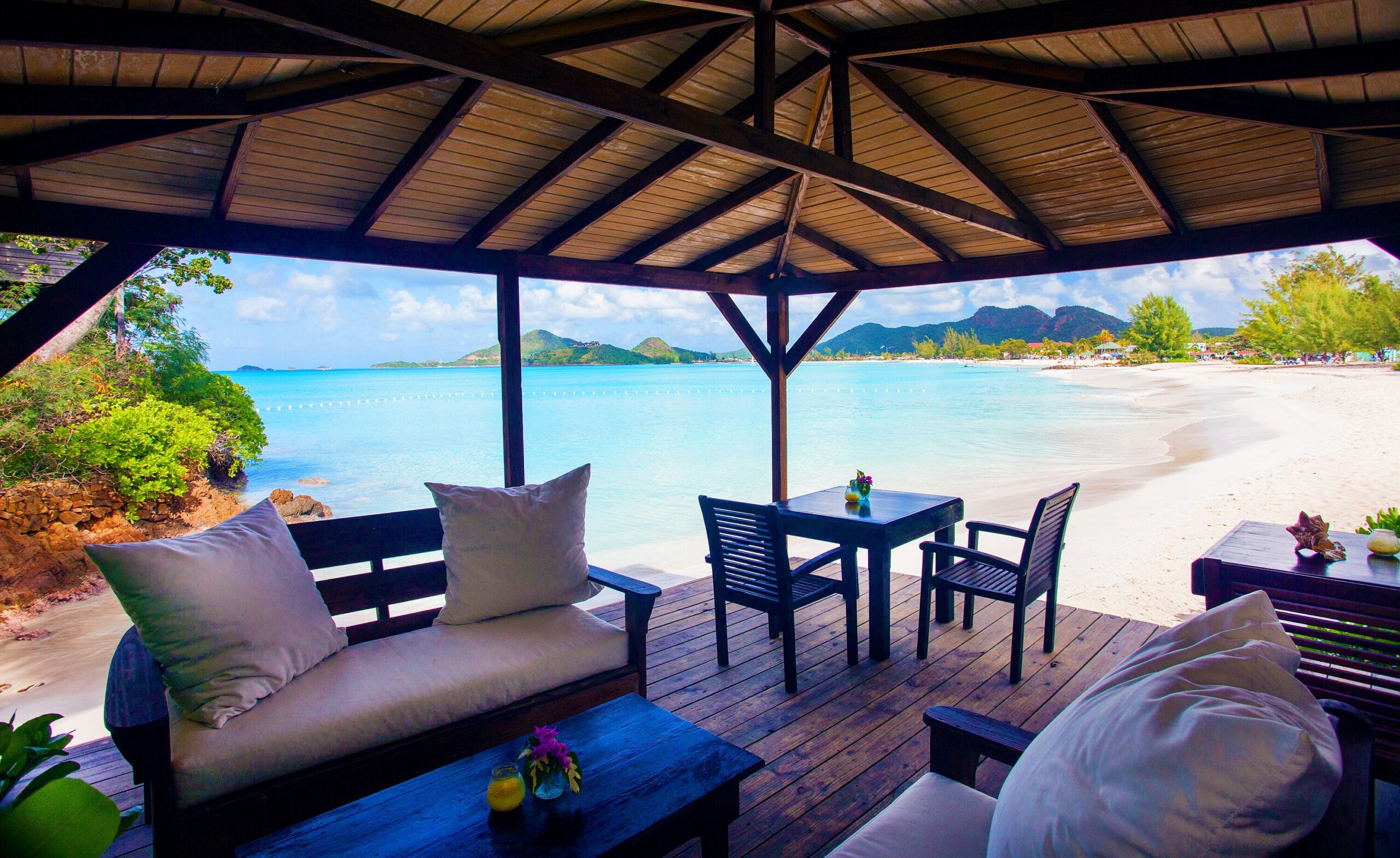 A shaded oceanview dining pavilion at Cocos Hotel Antigua