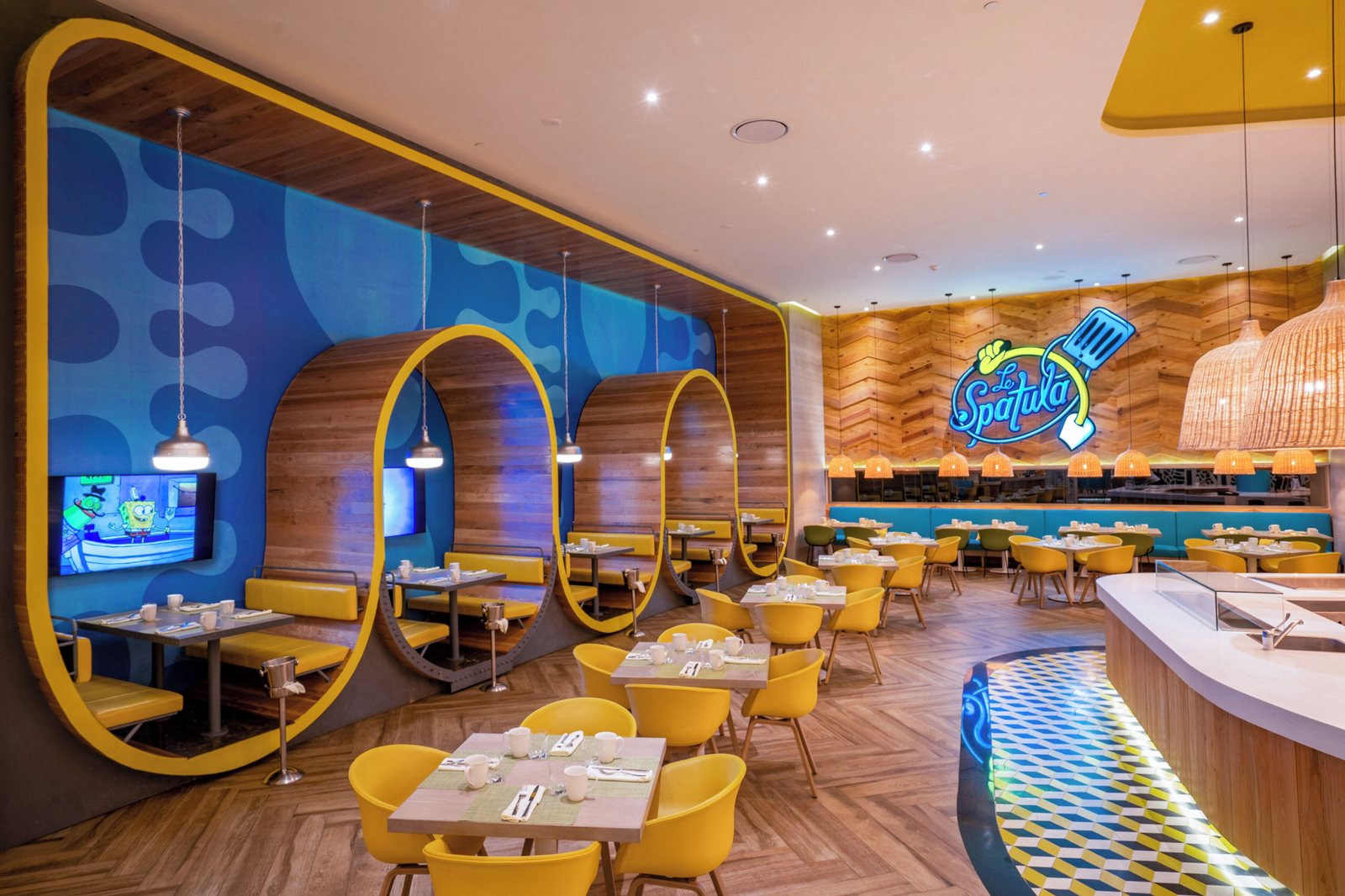 Le Spatula breakfast buffet restaurant with SpongeBob theming and yellow booths at Nickelodeon Riviera Maya