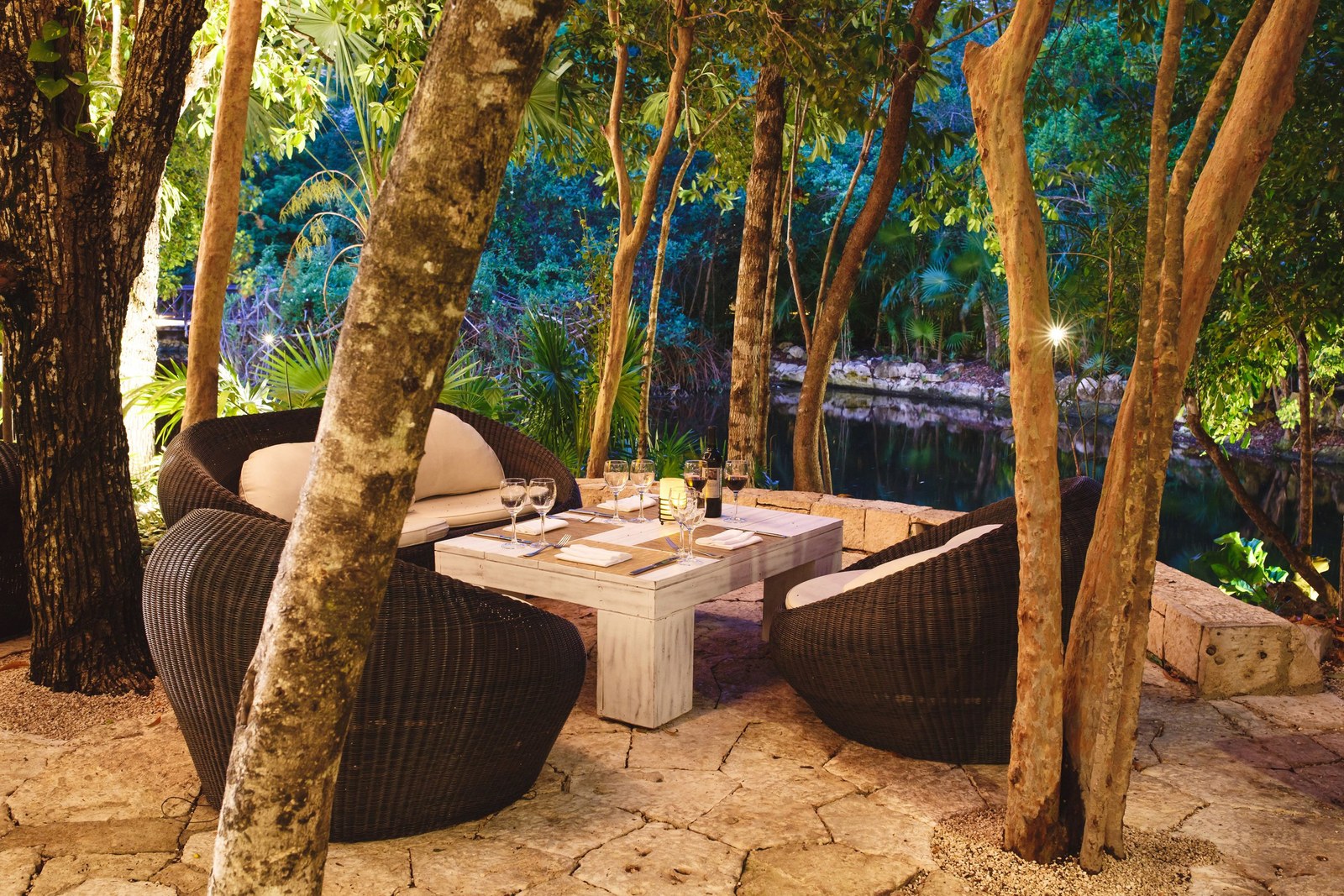 Outdoor dining tables under the trees at the resort