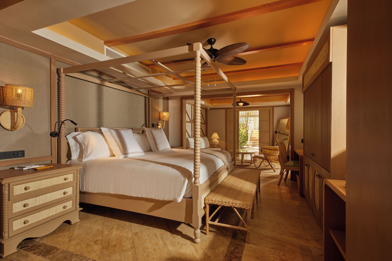 Junior suite at Cayo Levantado Resort with a four-poster bed, ceiling fan and terrace doors