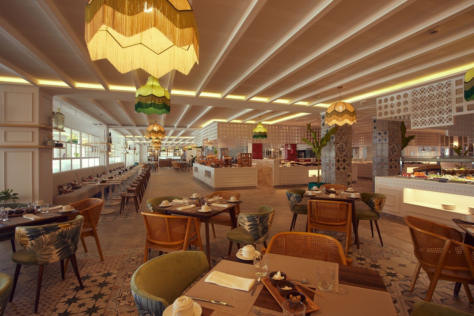 Dining room at Cayo Levantado Resort with set tables, rattan chairs and hanging lamps