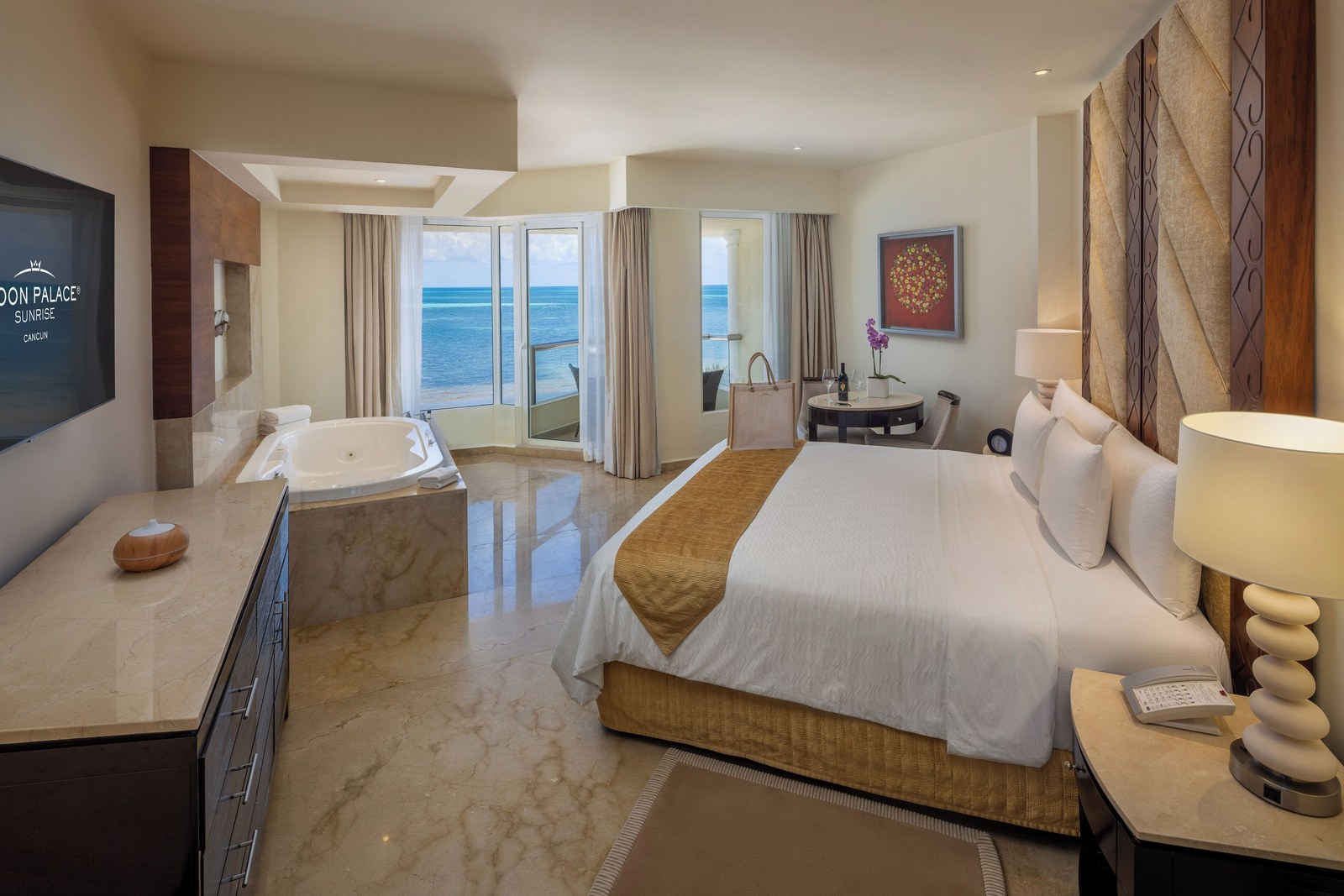 Guest room at Moon Palace Cancún with a king bed, in-room whirlpool tub and ocean view