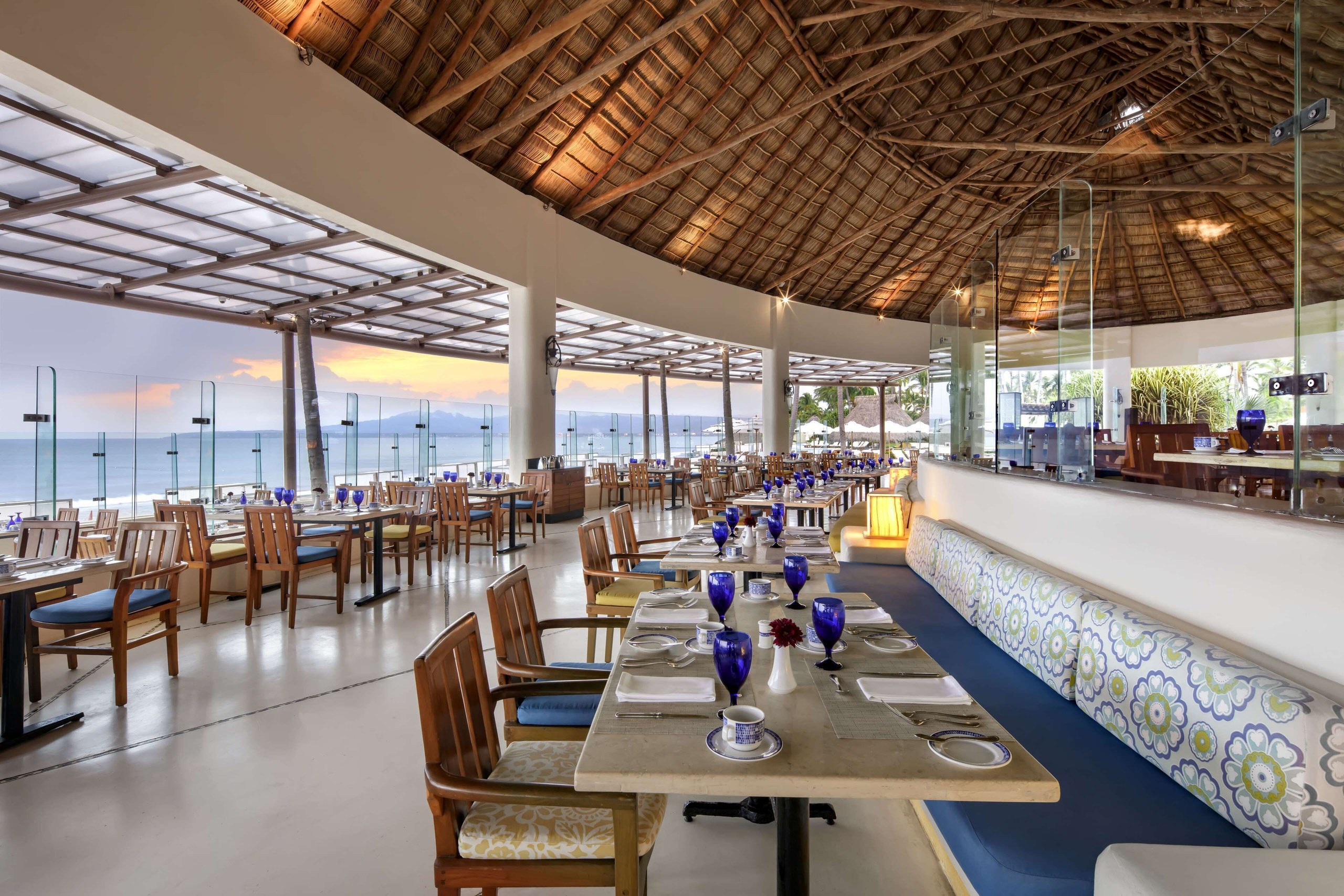 An open-air restaurant at Grand Velas Riviera Nayarit with tables set beside the ocean